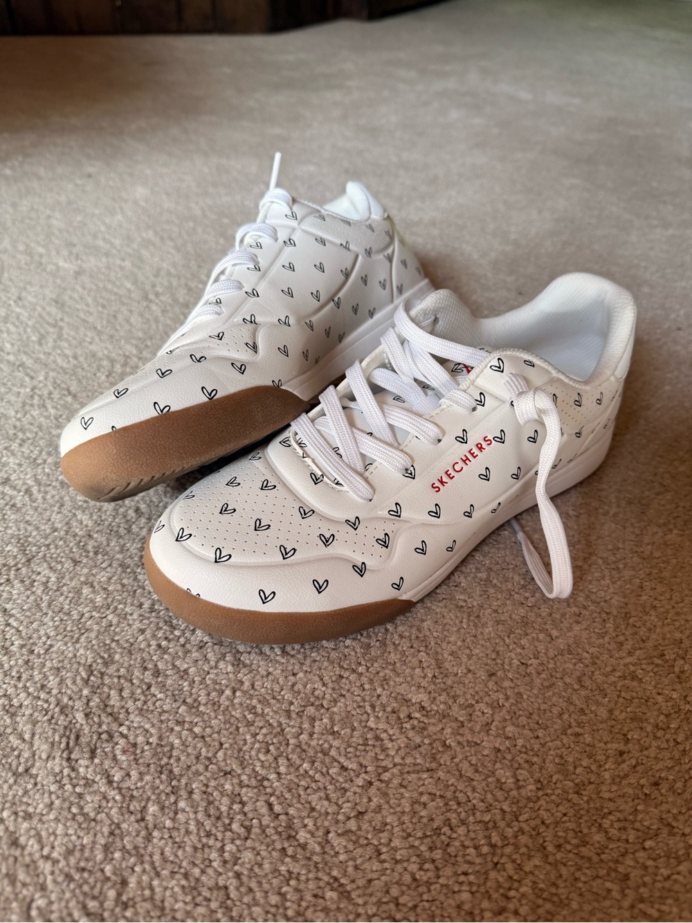 Skechers White Sneakers with Black Heart Print and Tan Outsole